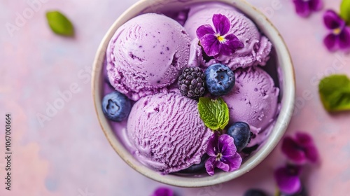 Beautiful vintage blueberry ice cream in a bowl with purple flowers decoration. Top view of delicious homemade ice cream.