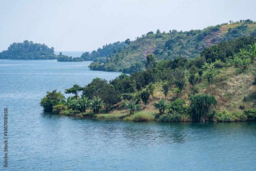 Obraz premium A sunset creates stunning colors over Lake Kivu with buildings nearby, Rwanda