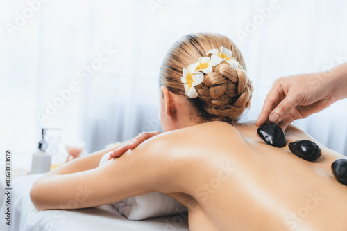Wallpaper Mural Hot stone massage at spa salon in luxury resort with day light serenity ambient, blissful woman customer enjoying spa basalt stone massage glide over body with soothing warmth. Quiescent Torontodigital.ca