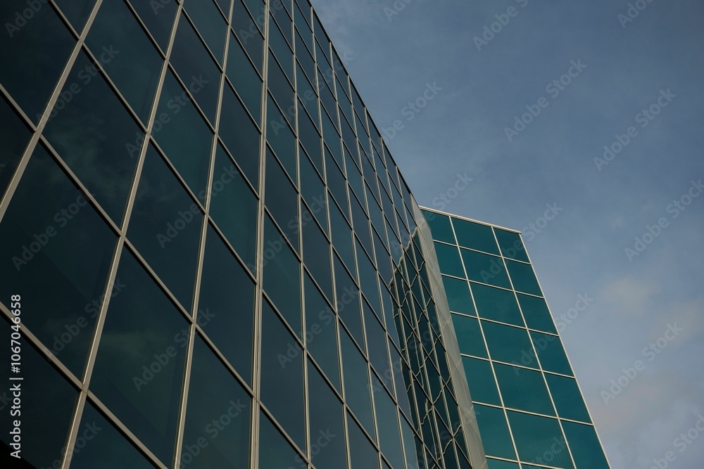 Modern glass building facade reflecting the sky. Modern glass building facade reflecting the sky.