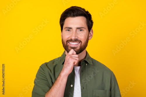 Portrait of nice young man hand chin think wear khaki shirt isolated on yellow color background