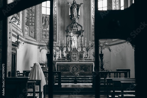 Fototapeta Nun praying in a historic church with ornate altar.