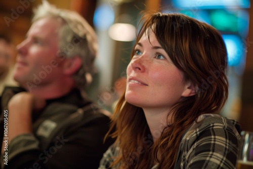 Couple sitting in a bar, looking at each other, smiling