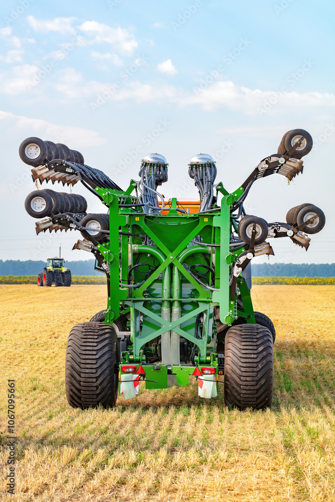 Advanced agricultural machinery working the fields during a sunny day in the countryside