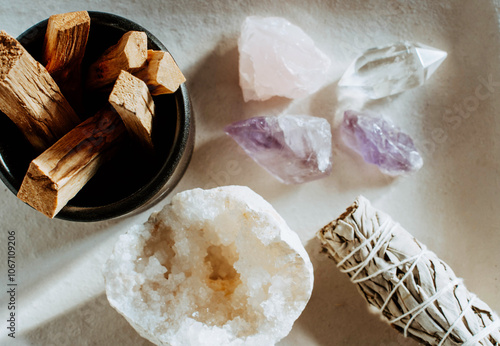 White sage and Palo Santo and amethyst and quartz crystals on a light beige background