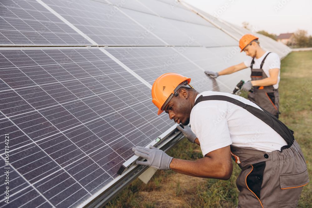 Technicians Installing Solar Panels at Renewable Energy Facility Technicians Installing Solar Panels at Renewable Energy Facility