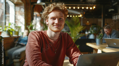 Student male freelancer works in inside cafe with laptop and coffee cup. Blend of work and leisure in a relaxed environment  photo