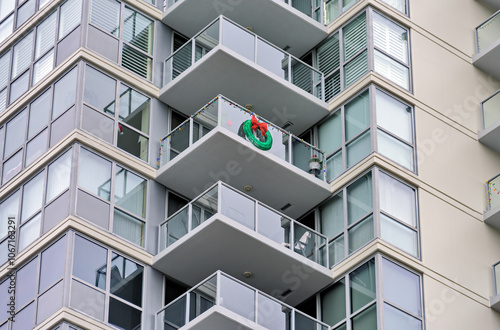 Corner of a residential high-rise building with balconies decorated for Christmas