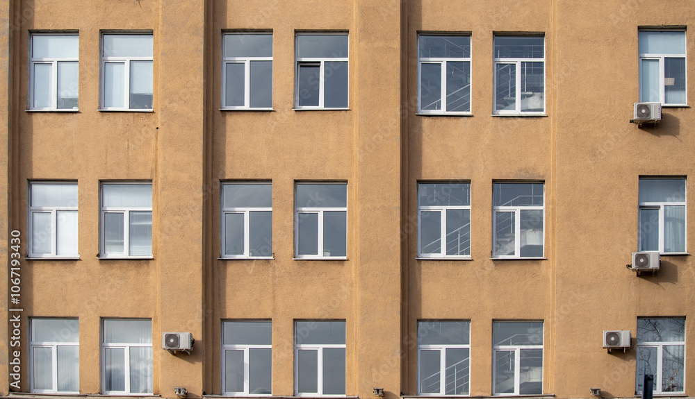 A row of tall buildings with many windows A row of tall buildings with many windows