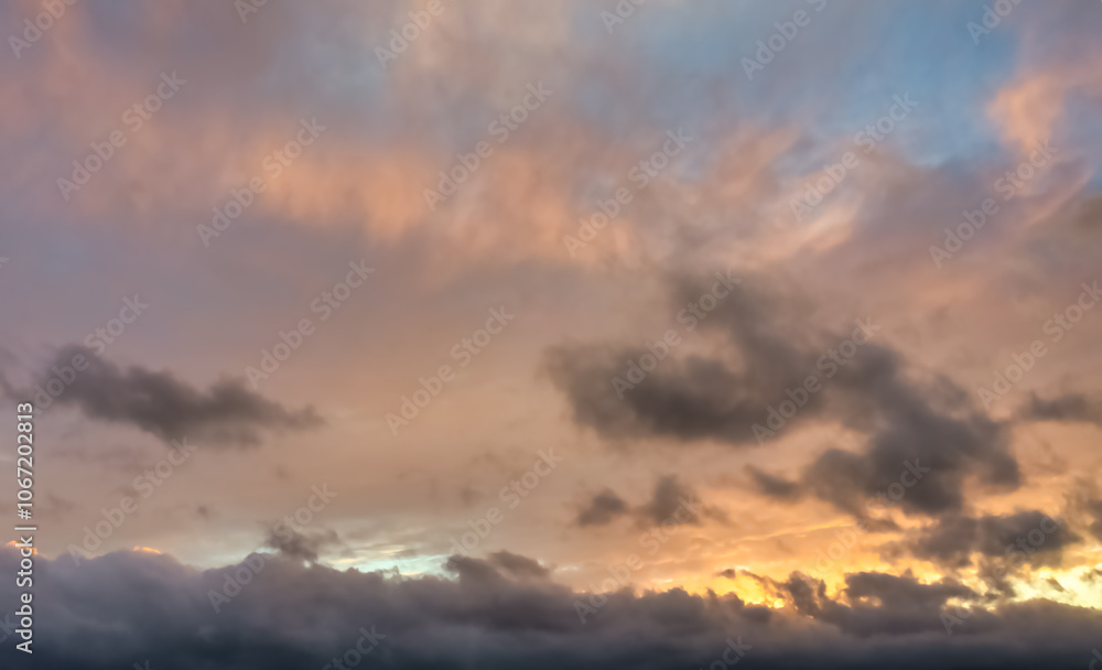 A beautiful sky tinted by the sun leaving vibrant shades of gold, pink, blue and multicolored. Clouds in the twilight evening and morning sky. Cloudy sky background in the evening, and during the day. A beautiful sky tinted by the sun leaving vibrant shades of gold, pink, blue and multicolored. Clouds in the twilight evening and morning sky. Cloudy sky background in the evening, and during the day.