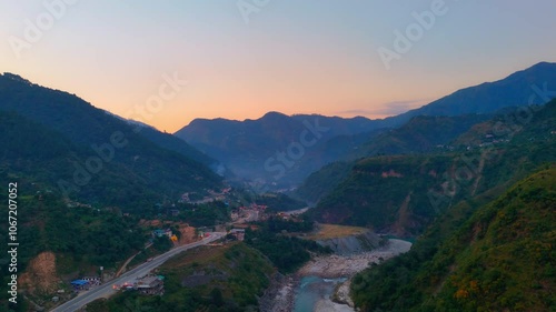 sunset landscape view drone shot of jibhi roads between the mountains valley photo