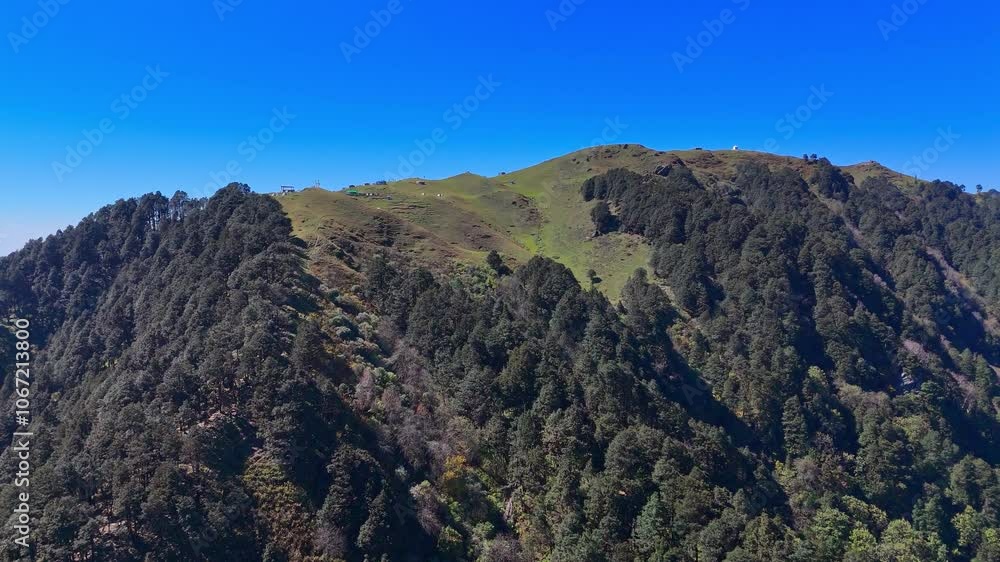 A beautiful valley with mountains and thick green forest views. A beautiful valley with mountains and thick green forest views.