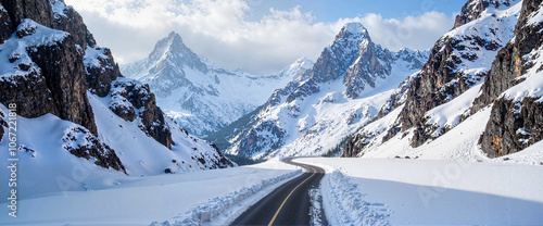 Winding road through snowy mountain landscape