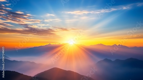 Sunrise over the mountains, a beautiful landscape with misty peaks and a blue sky