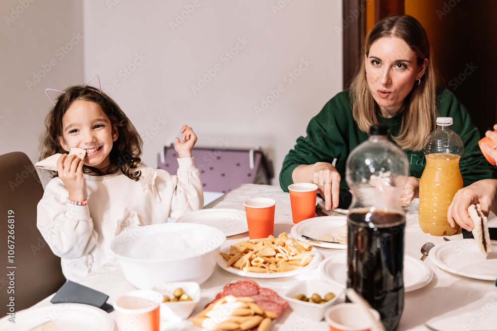 Mother and daughter enjoying snacks together at home. Lifestyle Mother and daughter enjoying snacks together at home. Lifestyle