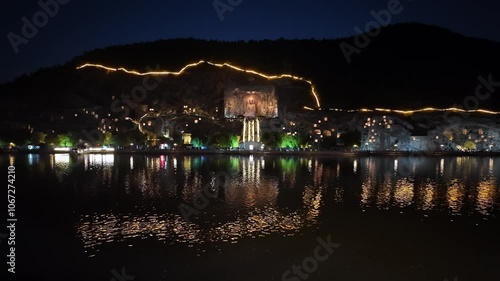 Luoyang, China: Panoramic footage of the famous Luoyang Longmen Grottoes with the famous Vairocana Buddha statue at night in Henan province in China.  photo