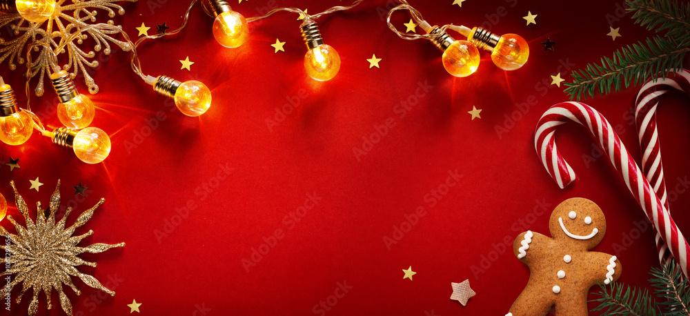 Christmas greeting card design with holiday decoration on red background; flat lay ornament; Xmas season banner or greeting card Christmas greeting card design with holiday decoration on red background; flat lay ornament; Xmas season banner or greeting card