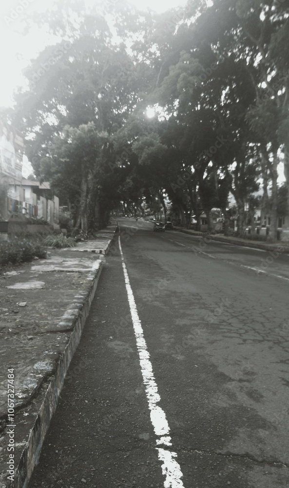 This is a black and white street view of a morning in Curup, Bengkulu, Indonesia. It's taken from a vertical perspective. This is a black and white street view of a morning in Curup, Bengkulu, Indonesia. It's taken from a vertical perspective.