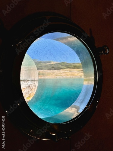 Obraz na płótnie The beautiful view of the water and the sky through the cabin port window in Mediterranean Sea w salonie