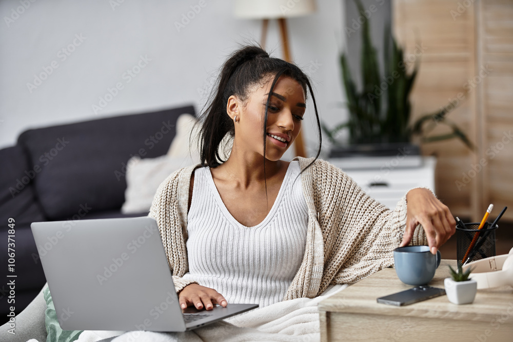 A beautiful woman is focused on her remote study session while relaxing at home. A beautiful woman is focused on her remote study session while relaxing at home.
