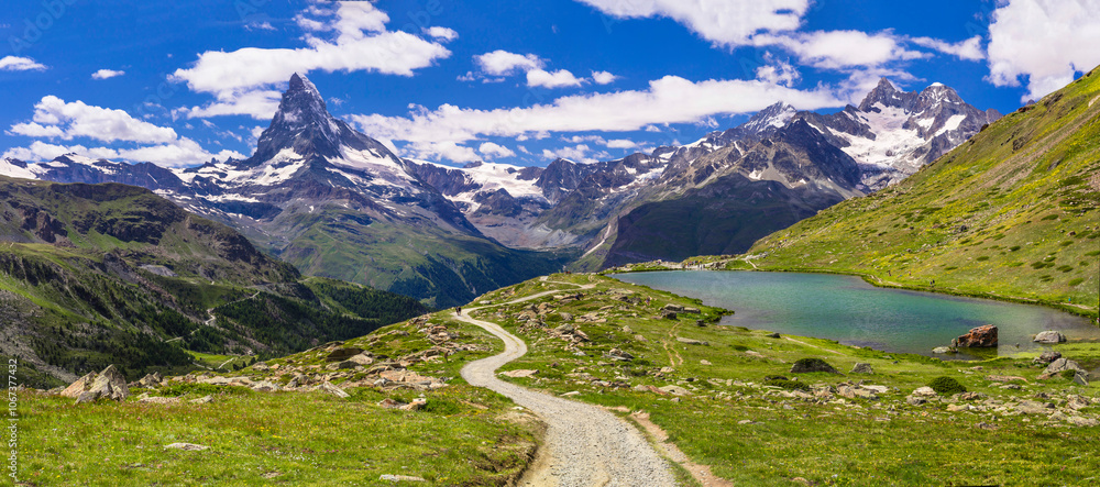 famous hiking routes in Switzerland , Valais canton - five most beautiful mountain lakes in Zermatt. Panoramic view of Stellisee lake and Matterhorn iconic mountain