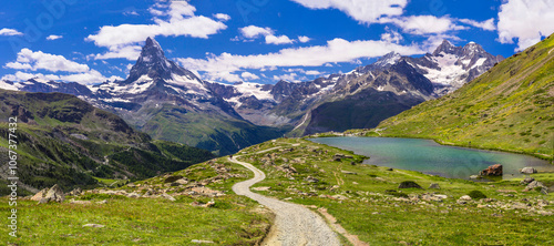 Obraz na płótnie famous hiking routes in Switzerland , Valais canton - five most beautiful mountain lakes in Zermatt. Panoramic view of Stellisee lake and Matterhorn iconic mountain w salonie