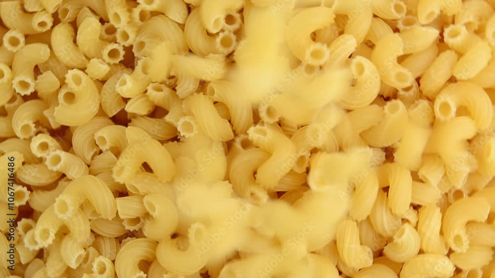 Raw pasta cones spin and fall from the top. View from above. Raw pasta cones spin and fall from the top. View from above.