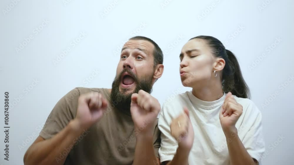 Young married couple in love dancing funny while sitting at home. Newlyweds joyfully dance and have fun. Young married couple in love dancing funny while sitting at home. Newlyweds joyfully dance and have fun.