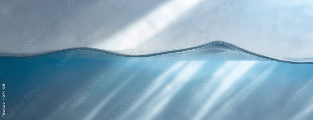 Blue water surface with sunlight reflections against a white background, showing a gentle wave curve.