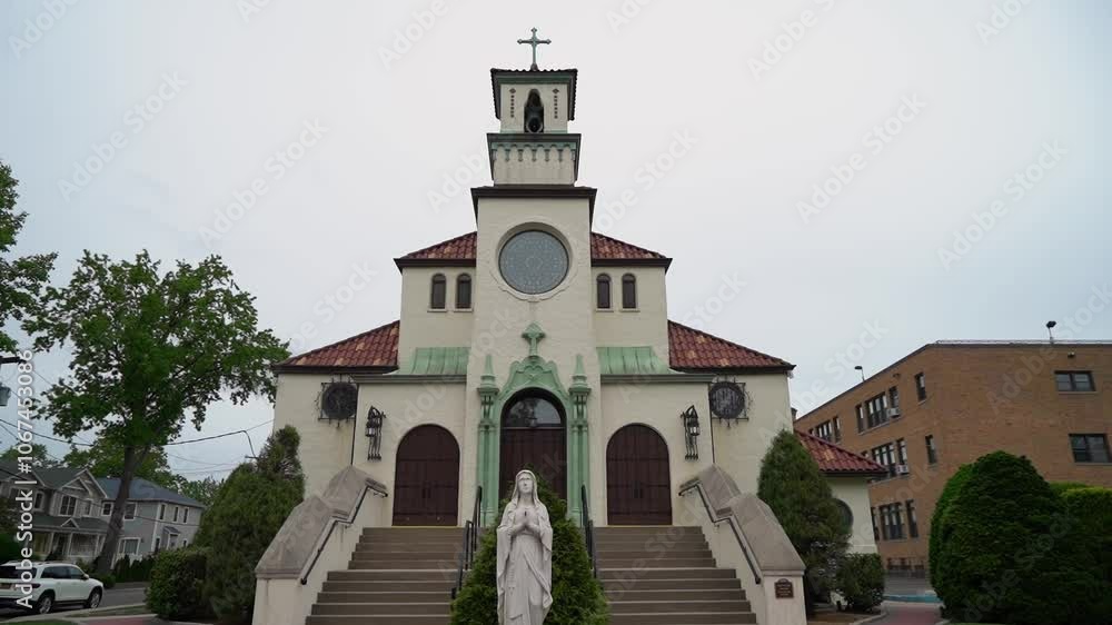 A stunning church facade with intricate architecture and a beautiful statue stands against a cloudy sky, inviting people for worship, reflection, and moments of serenity and spirituality A stunning church facade with intricate architecture and a beautiful statue stands against a cloudy sky, inviting people for worship, reflection, and moments of serenity and spirituality