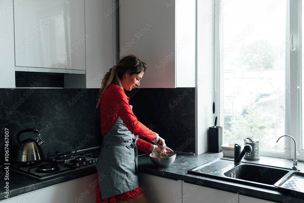 Beautiful woman housewife in red dress cooking food in kitchen Beautiful woman housewife in red dress cooking food in kitchen