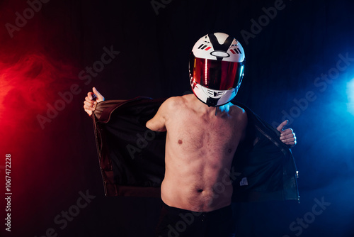 Man in a motorcycle helmet on a bare torso photo