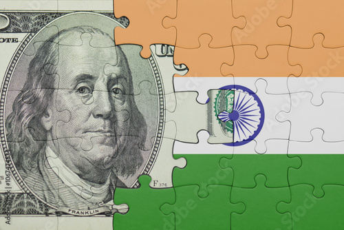 puzzle with the national flag of india and the usa dollar money .finance concept