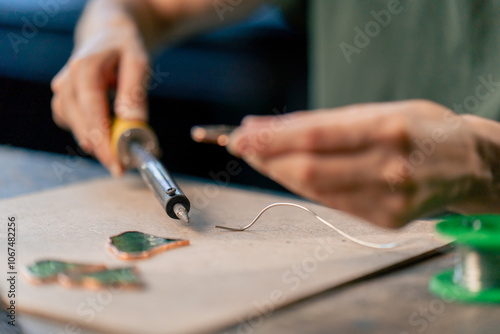 Canvas Print close up in a large green workshop on a woman with green hair creates decorative