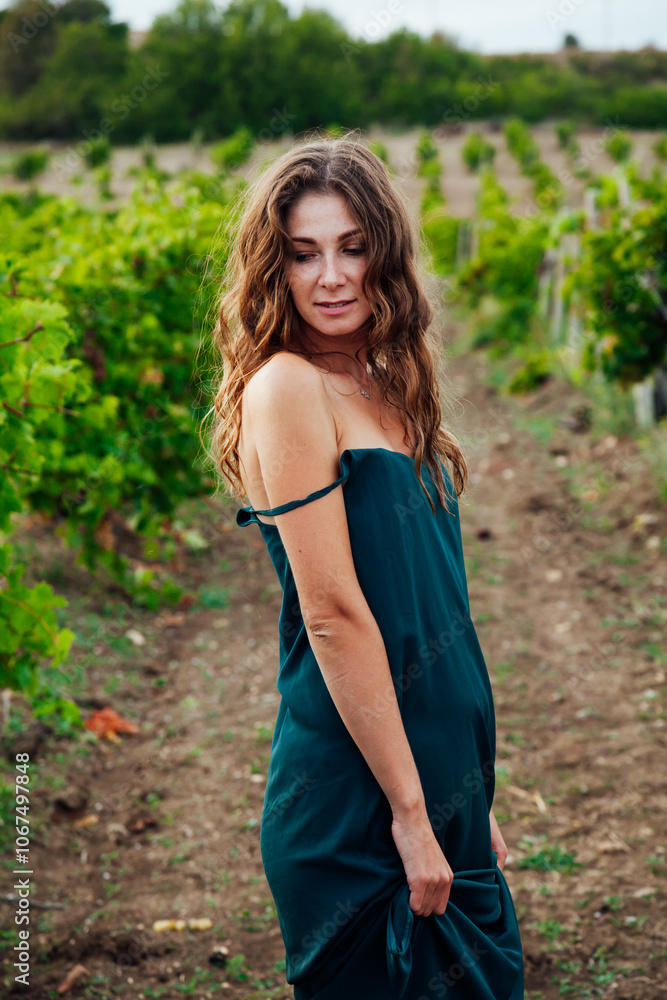 Beautiful woman walking in vineyard before harvest Beautiful woman walking in vineyard before harvest