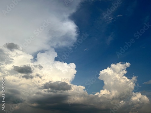 A picturesque sky featuring various cloud formations against a backdrop of deep blue, showcasing the beauty of nature. photo