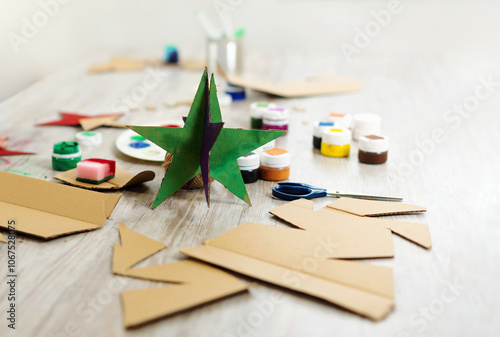 Handmade stars from cardboard. Eco-friendly handicraft and Christmas decorations and ornaments. Children design cardboard decorations.