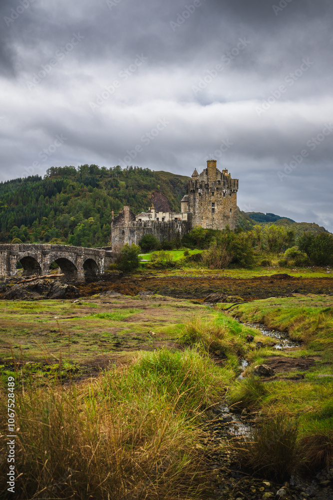 Fototapeta premium Eilean Donan Castle, highlands of scenic Scotland on cloudy day. Portrait orientation.