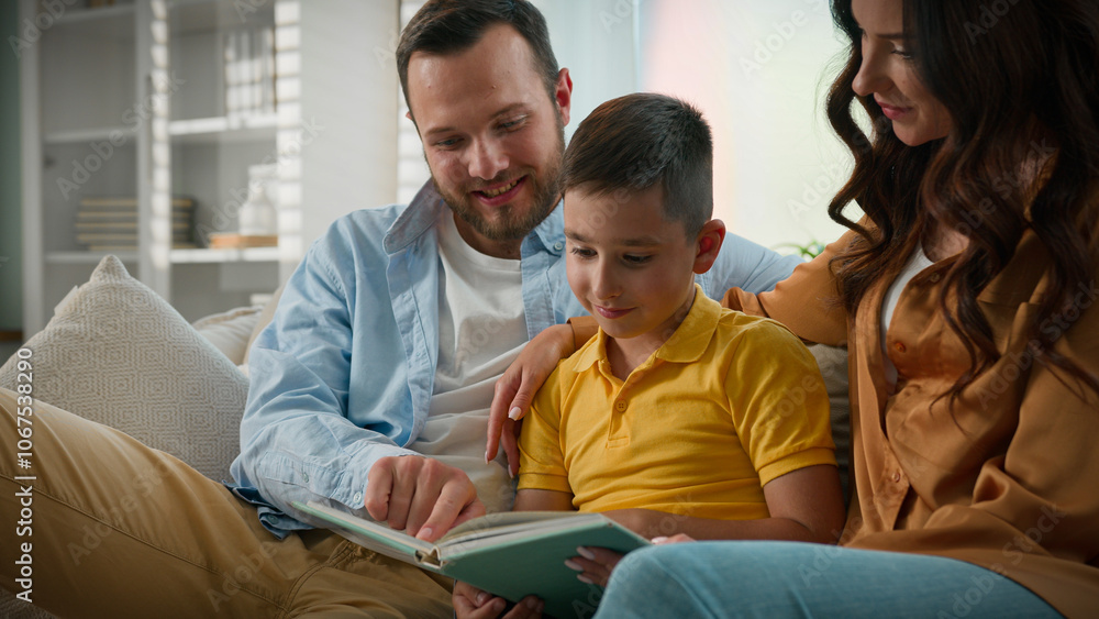 Caucasian mother father son reading book in cozy living room on couch spending weekend together caring loving parents storytelling boy child enjoying read fairytale relax happy family relationships Caucasian mother father son reading book in cozy living room on couch spending weekend together caring loving parents storytelling boy child enjoying read fairytale relax happy family relationships