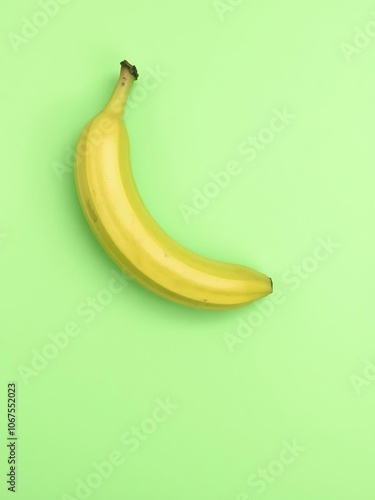 Green fresh banana placed on a vibrant green background, food, vibrant green