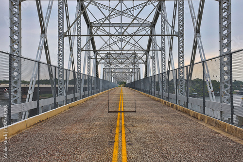 Old Buchanan Dam highway iron truss bridge, converted to a pedestrian bridge with swings installed for those photo ops. photo