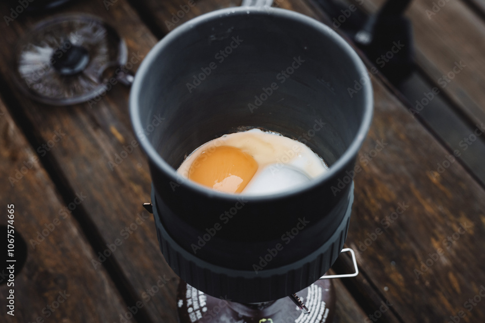 Egg cooking in a camping gas cooker Egg cooking in a camping gas cooker