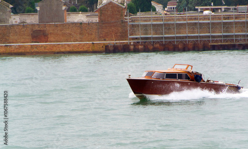 Water Taxi Cruising Through Venetian Lagoon photo