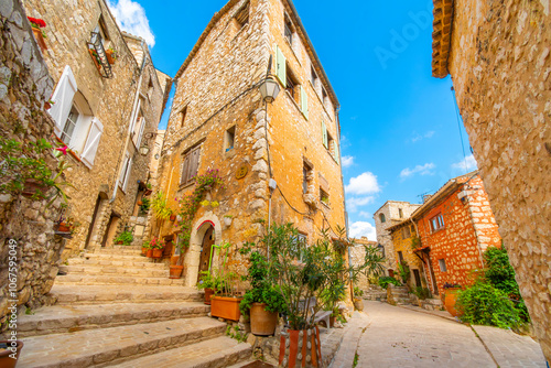 Colorful medieval stone buildings along the Grand Rue main street through the hilltop village of Tourrettes-sur-Loup, Grance, in the Alpes-Maritimes region of Southern France. photo