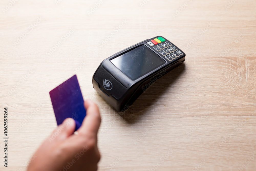 Customer paying with contactless credit card on pos terminal Customer paying with contactless credit card on pos terminal
