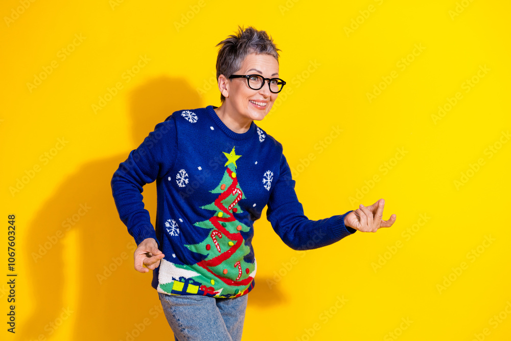 Photo of holly jolly cute senior woman wear blue stylish clothes empty space isolated on yellow vivid color background Photo of holly jolly cute senior woman wear blue stylish clothes empty space isolated on yellow vivid color background