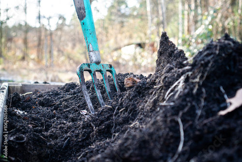 Foto Close-up of a pitchfork in a raised garden bed filled with rich black compost an