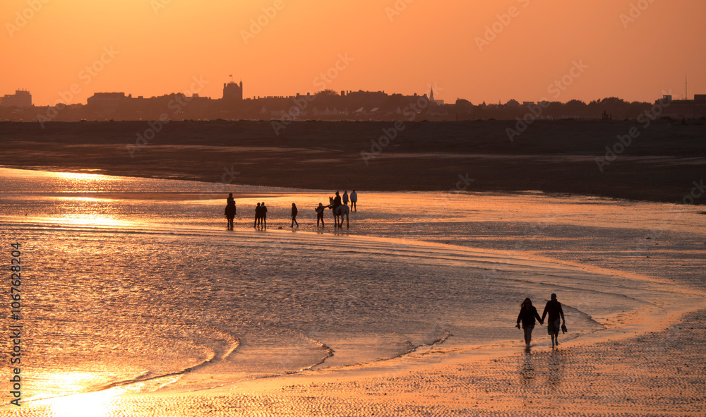 Beach at south end of Hayling island is turned golden by sunset
