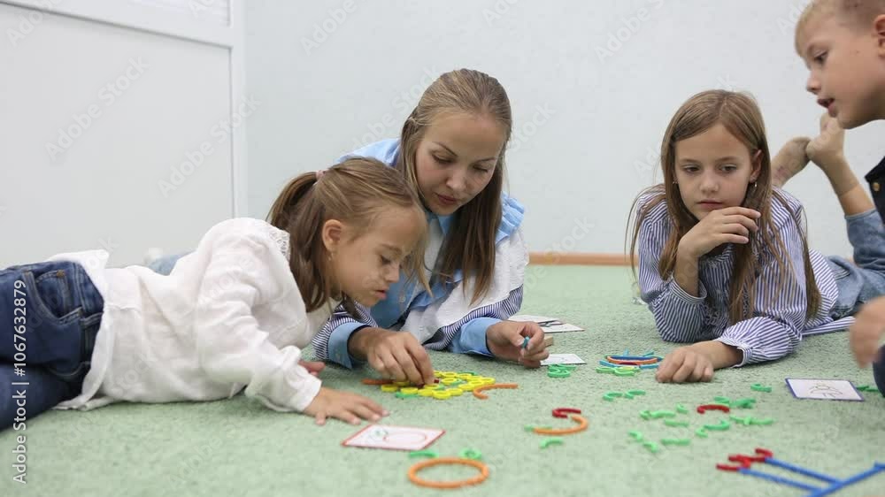 children with a teacher at a kindergarten class children with a teacher at a kindergarten class