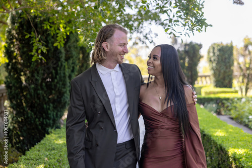 A stunning engagement photoshoot beautifully capturing a mixed couple immersed in a romantic outdoor setting, showcasing the depth of their love and unwavering commitment to one another